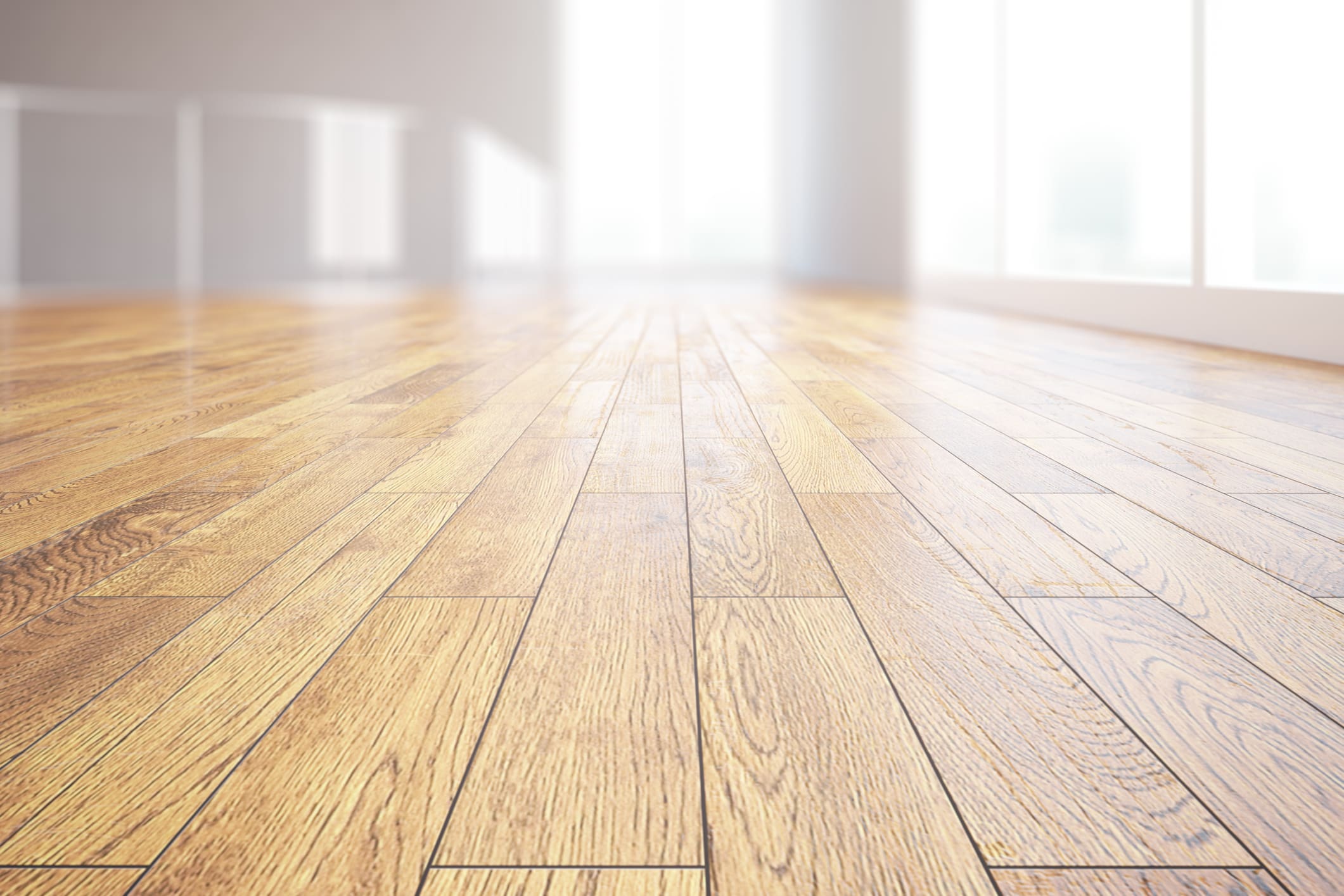 Sunlit room with wooden floorboards.
